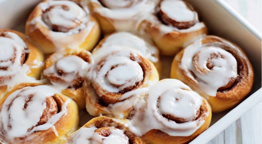 tray of cinnamon buns with icing